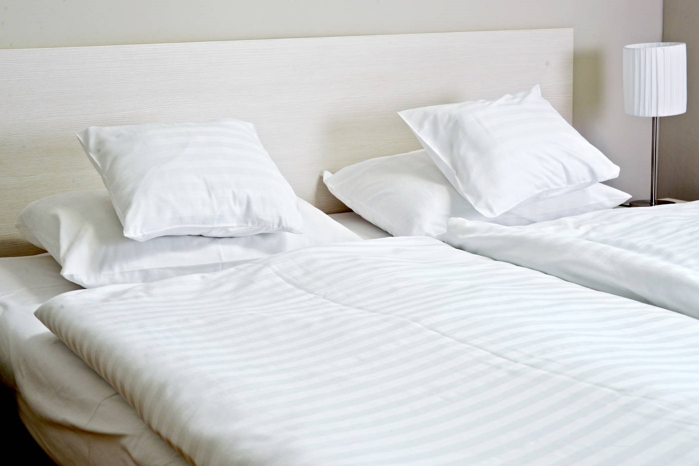 différentes tailles d'oreillers posé sur un lit d'hôtel